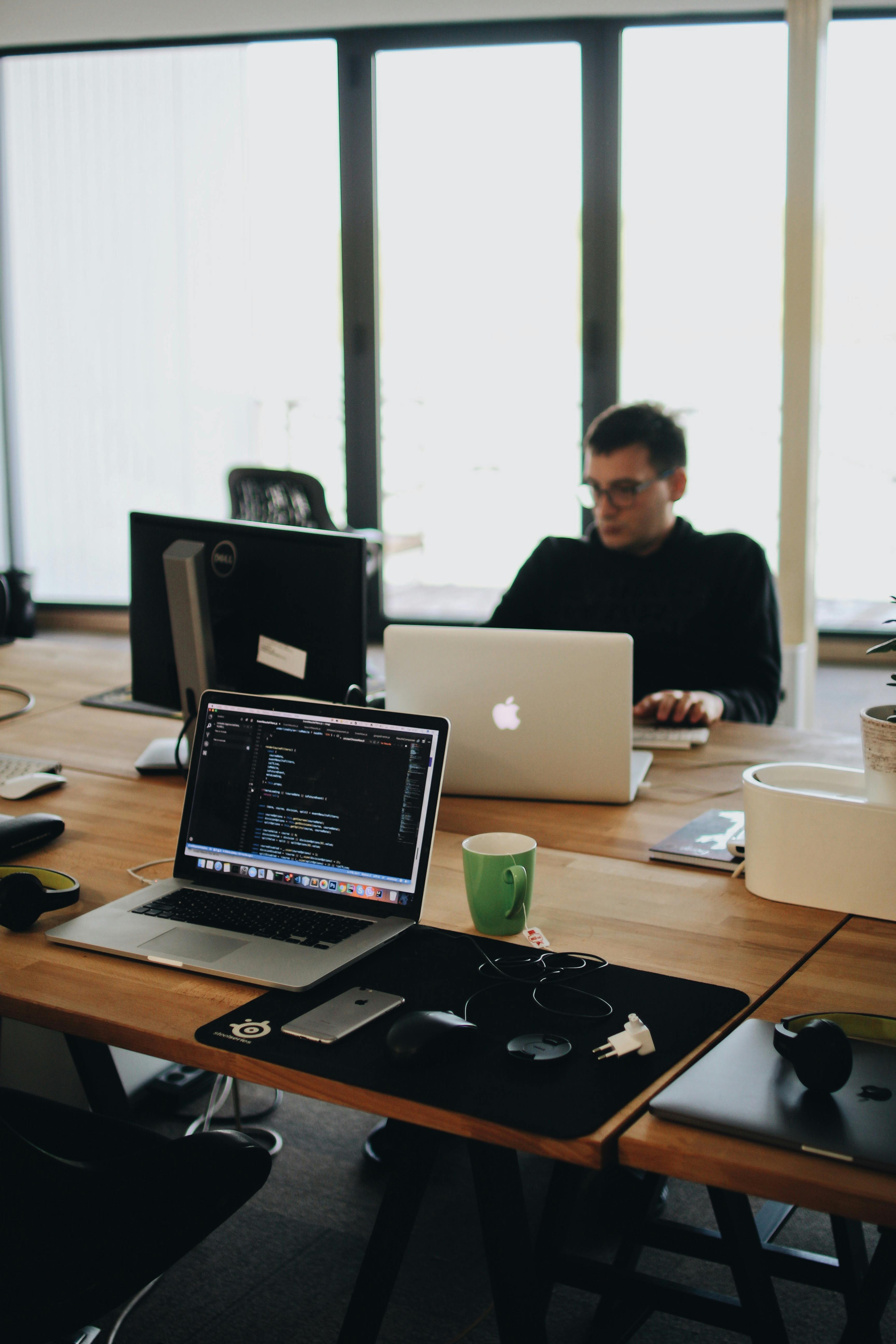 Software developer coding at a tech startup who needs legal support to grow his business